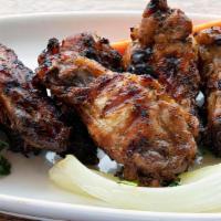 Wood Grilled Chicken Wings · served with our house mumbo sauce