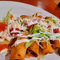 Chicken Flautas  · 4 Crispy corn tortilla wrapped with chicken and potatoes topped with lettuce tomatoes cheese...