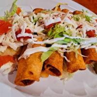Cheese Flautas  · Crispy corn tortillas wrapped with mexican  queso fresco topped with lettuce tomatoes cheese...