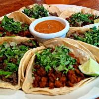 Al Pastor Taco · (pork marinated with onions and pineapple) topped with cilantro and onions