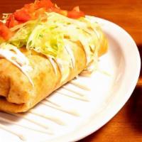 Steak Chimichanga · flour tortillas loaded with refried beans, rice and cheese topped with lettuce tomatoes and ...