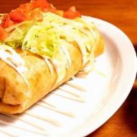 Shrimp Chimichanga · flour tortillas loaded with refried beans, rice and cheese topped with lettuce tomatoes and ...