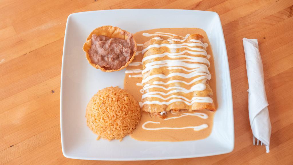 Carnitas Enchiladas · Three stuffed corn tortillas, topped with melted mozzarella cheese, and sour cream. Served with rice and beans.