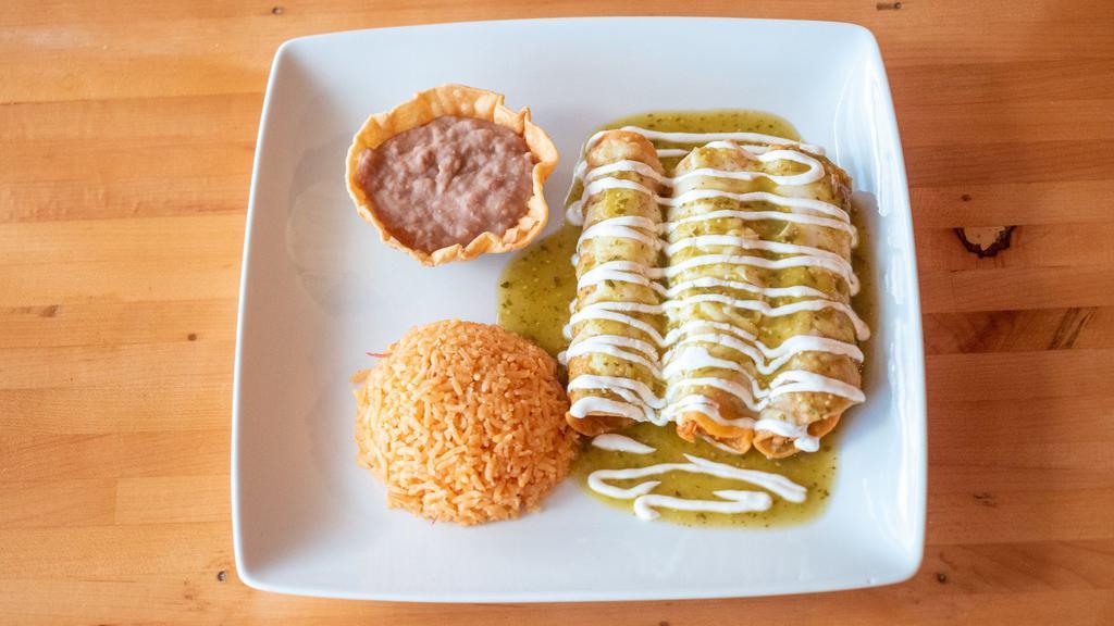 Birria Enchiladas · (Birria-cook slowly beef) three  stuffed corn tortillas, topped with melted mozzarella cheese, and sour cream. Served with rice and beans.