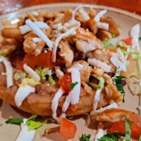 Grilled Chicken Sope · Fresh, flat corn tortilla, spread with beans, topped with lettuce, tomatoes,  cheese (mexica...