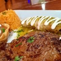 Ribeye La Tampiqueña  · 12oz. of ribeye steak served with 1 tinga enchilada topped with melted cheese and tomatillo ...