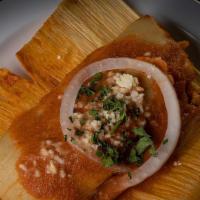 Chuchitos · Small Guatemalan chicken tamale in tomato sauce, wrapped in corn husk and garnish with sheer...