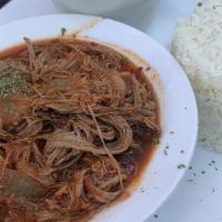 Ropa Vieja · Braised shredded beef with sauteed onions red peppers, onions, garlic and sofrito.