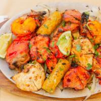 Tandoori Mixed Grill( Signature Dish) · A combination tandoori chicken, seekh kebab, shrimp tandoori, boti kebab, and chicken tikka.