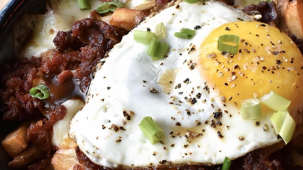 Loaded Poutine · Hand-cut fries, mozzarella cheese curds, crumbled  linguica, sunny side-up egg*, steak sauce