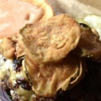 Fancy Burger · Hand ground burger patty, bacon jam, smoked gouda, fried pickles,  red onion, greens, srirac...