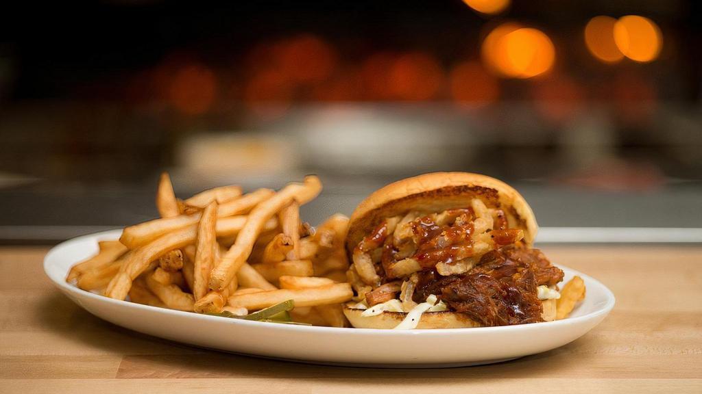 Pulled Pork Sandwich · cole slaw, fried onion straws,  pineapple  chipotle BBQ sauce