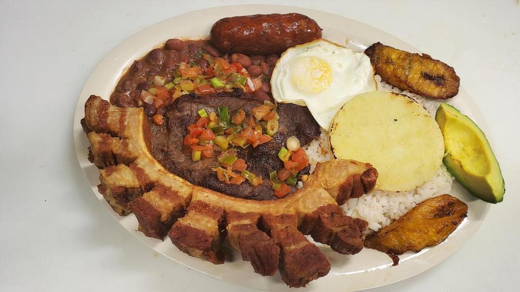Bandeja Paisa Con Carne Asada · Grilled Steak, rice, beans, pork ring, 
Colombian sausage, fried egg, Sweet plantain, avocado, corn cake