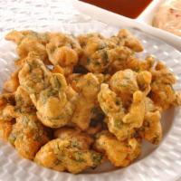 Mixed Pakora · A delicious assortment of fried vegetable fritters including fresh ingredients such as cauli...