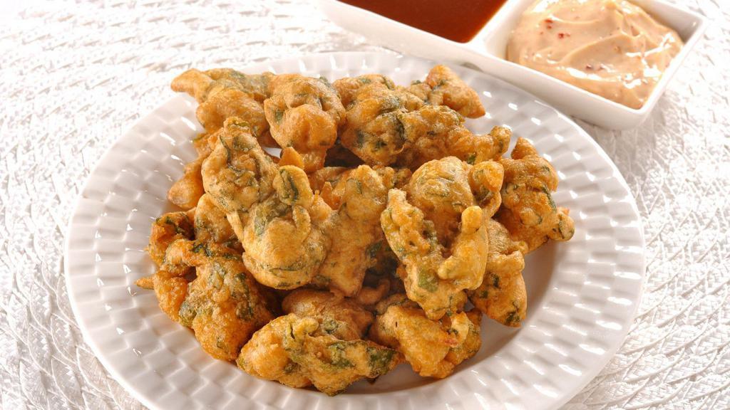 Mixed Pakora · A delicious assortment of fried vegetable fritters including fresh ingredients such as cauliflower, onions, potatoes and spinach.