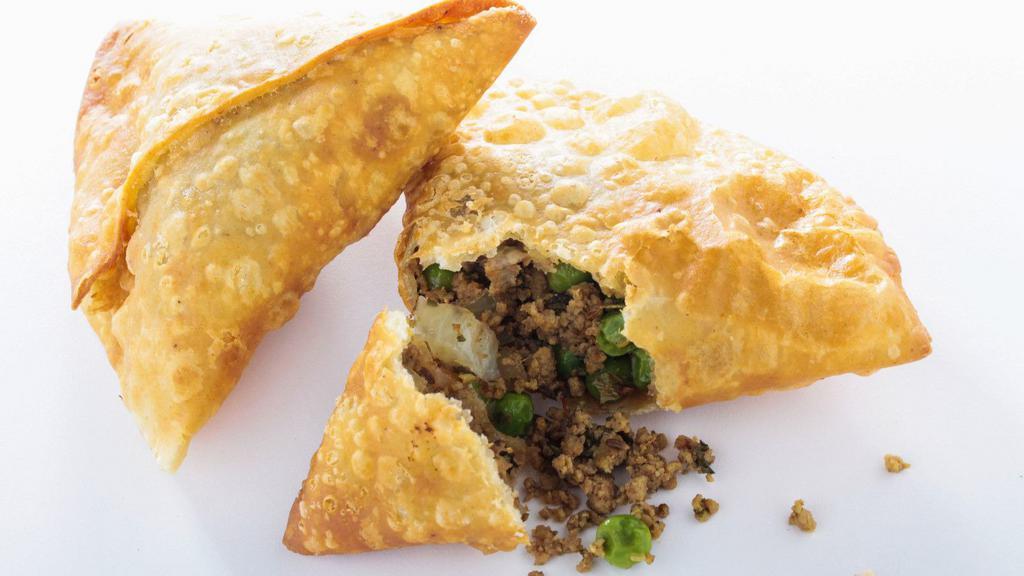 Lamb Samosa · Deliciously golden fried, crispy triangular pastry turnovers, filled with minced lamb, seasoned with a mixture of potatoes and green peas.