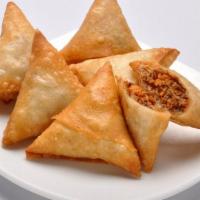 Chicken Samosa · A delicious three piece pastry, stuffed with ground chicken and peas.