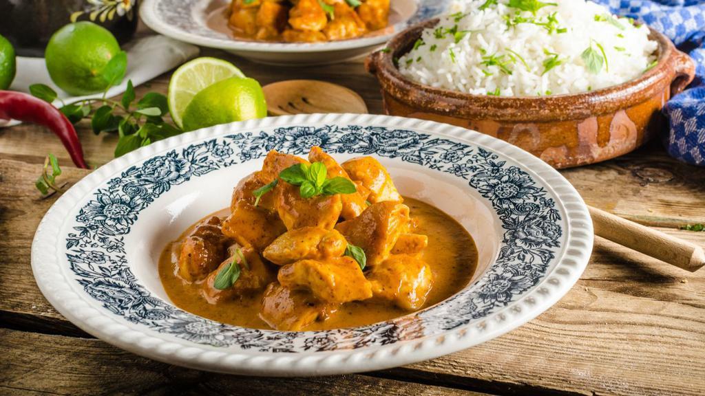 Chicken Shahi Korma · Delicious tender chicken flavored with cardamom sweet and spicy cream, mixed with cashews and raisins.