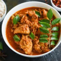 Chicken Madras · Delicious chicken cooked with roasted coconut, mustard seed and hot chili peppers.