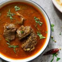 Goat Vindaloo · Delicious marinated bone-in goat, cooked with potatoes in a spiced and tangy vinaigrette sau...