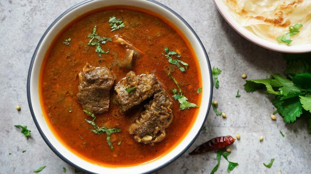 Goat Vindaloo · Delicious marinated bone-in goat, cooked with potatoes in a spiced and tangy vinaigrette sauce.