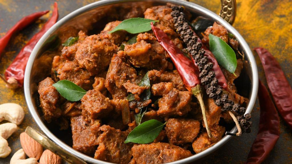 Goat Bhuna · Delicious marinated bone-in goat, cooked with tomatoes, onions and various spices. Served with a side of basmati rice.