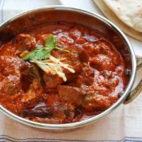 Goat Korma · Delicious marinated bone-in goat, with mughlai delight cardamoms flavored sweet and spicy cr...