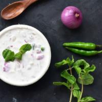 Raita · Deliciously fresh yogurt with cucumber, carrot, tomatoes, red onions and herbs.