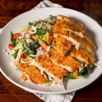 Southwest Chicken Salad · Grilled spiced chicken on a bed of fresh mixed greens and a blend of red onions, tomatoes, c...