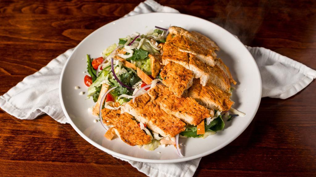 Southwest Chicken Salad · Grilled spiced chicken on a bed of fresh mixed greens and a blend of red onions, tomatoes, cheese, corn kernels, black beans and crispy tortilla chips. Served with southwest ranch dressing.