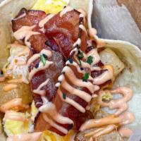 Breakfast Taco · Single taco with eggs, home fries, cheese, your choice of protein. Drizzled with sauce and g...