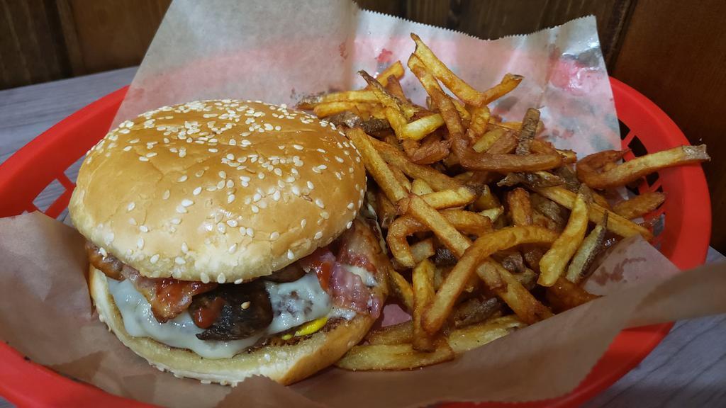 Mushroom Swiss Meal · Burgers come with lettuce, tomato, onion, pickle, mayo, mustard and ketchup, your choice of cheese, chips and a soda.  Upgrade to fries for an additional cost. (bacon in picture added at an extra charge)