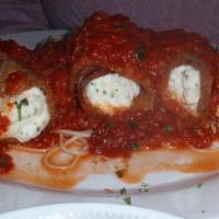 Eggplant Rollatini · Grilled eggplant with ricotta cheese baked in oven finished with marinara sauce.