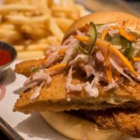 Fish Sandwich · Deep fried flounder, escabeche slae, jalpeño/caper tartar and french fries on a potato roll.