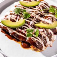Chicken Enchiladas · Adobo chicken tinga, cheese blend, crema, homemade spiced mole, avocado, sesame