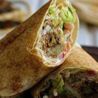 Falafel Hummus Wrap · Vegan Falafel crumble with hummus original wrapped in a wheat wrap with Spinach tomato.