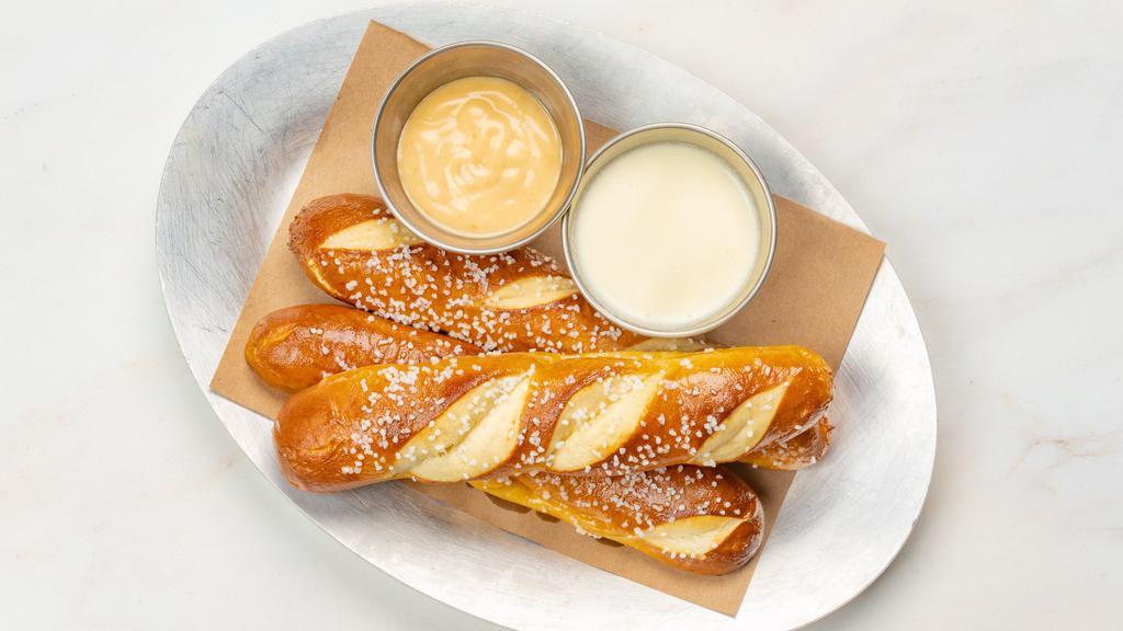 Pretzel · Fresh baked Bavarian pretzels (3) brushed with butter and salt. Served with honey mustard and warm cheese sauce.