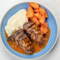 Tenderloin & Gravy · Seared beef tenderloin tails served with onion gravy, mash potatoes and daily vegetable.