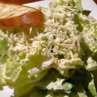Caesar Salad · Crisp romaine, parmesan and grilled croutons tossed in a traditional homemade Caesar dressing.
