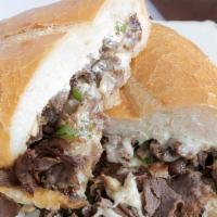 Beef/Lamb Cheesesteak · Middle Eastern cuisine consisting of beef and lamb cut into thin slices, stacked in a cone-l...