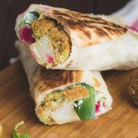Falafel Saj Wrap · A staple Middle Eastern dish—Deep fried ground chickpeas with your choice of toppings on a f...