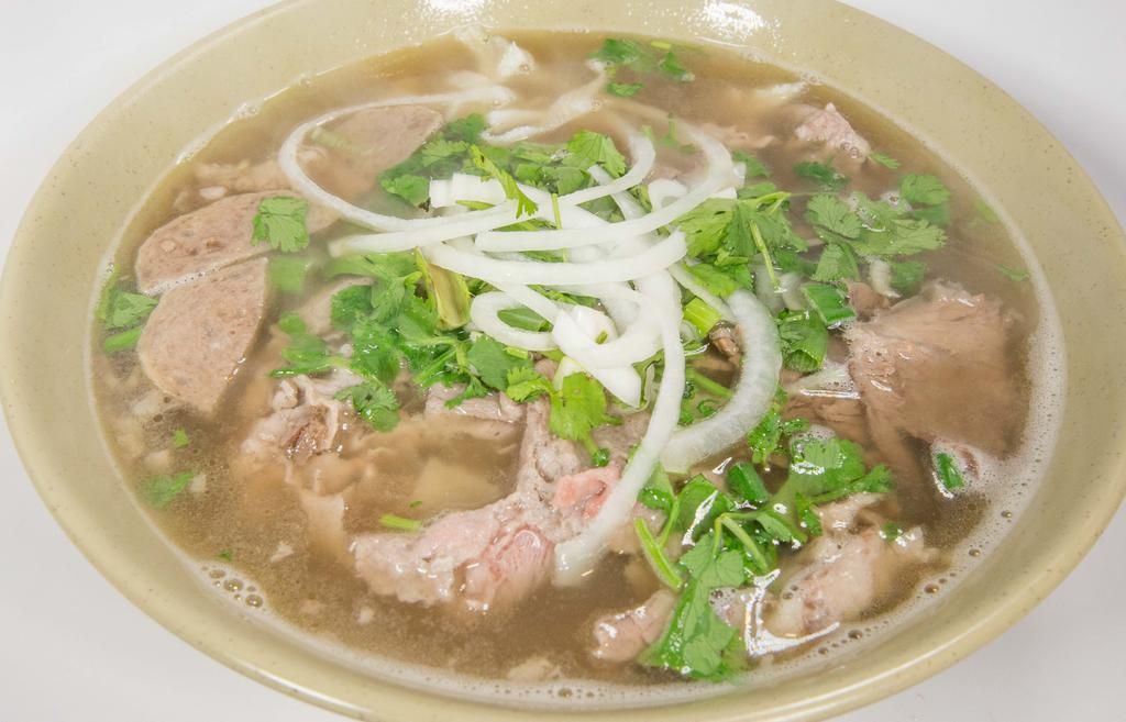 Beef Pho Special (Pho Bo Dac Biet) · Large bowl Pho includes rib-eye steak, beef brisket, and meatballs.  Garnished with onions and cilantro