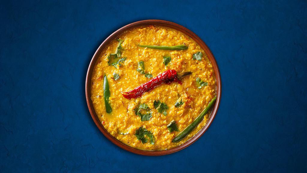 Divine Yellow Lentils  · Yellow lentils, slow-cooked to perfection and tempered with cumin, garlic, and chilies.