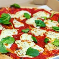 Margherita Pizza · Fresh mozzarella, basil, olive oil and mild spicy sauce.