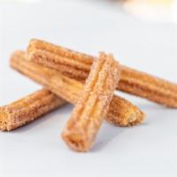 Churro · Fried churro with cinnamon and sugar.