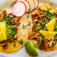 Pork & Pineapple / Al Pastor Tacos Trios · Topped with cilantro, onions and limes.