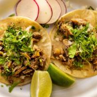Pork Carnitas (Deep Fried Pork) Tacos Trios · Topped with cilantro, onions and limes.