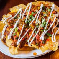 Nachos Grande · fresh tortillas piled high, topped with homemade chili,    cheese blend, fresh salsa, jalape...