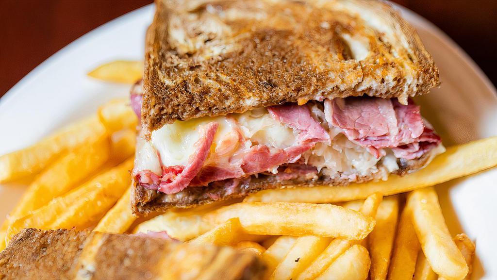 Reuben · a classic ... corned beef, piled high with sauerkraut, melted swiss cheese and thousand island dressing on marble rye bread,  served with french fries.