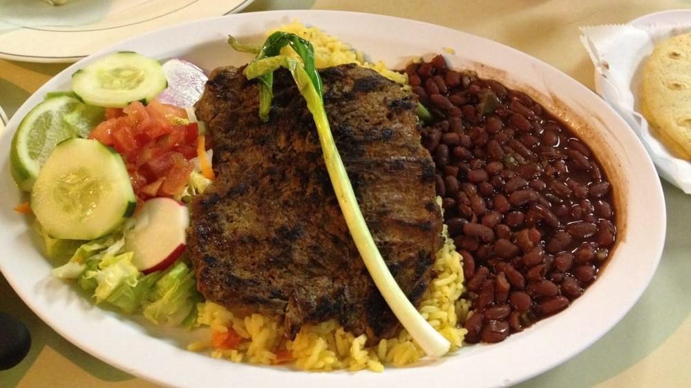 Carne Asada · Grilled beef, rice, beans, salad, tortillas.